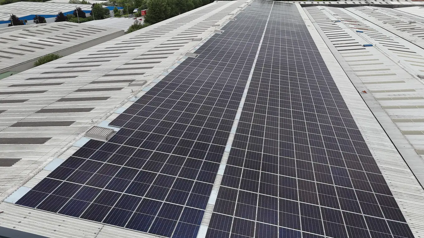 Close aerial view along rows of solar panels on the FDC warehouse roof