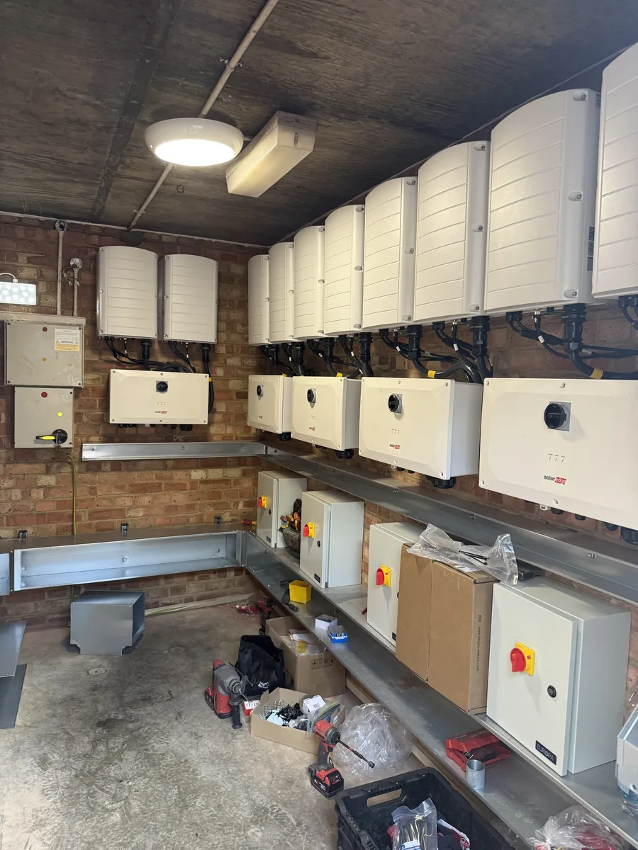 Inverter room with wall-mounted inverters and isolators being installed