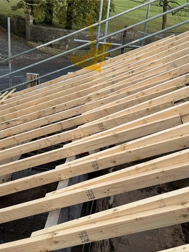 Close view of new softwood rafters fixed over the barn walls