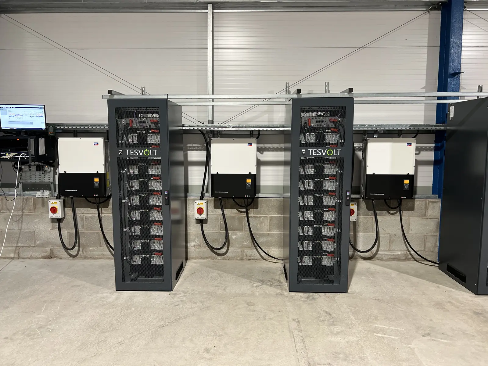 Battery energy storage cabinets and inverters installed in a commercial plant room