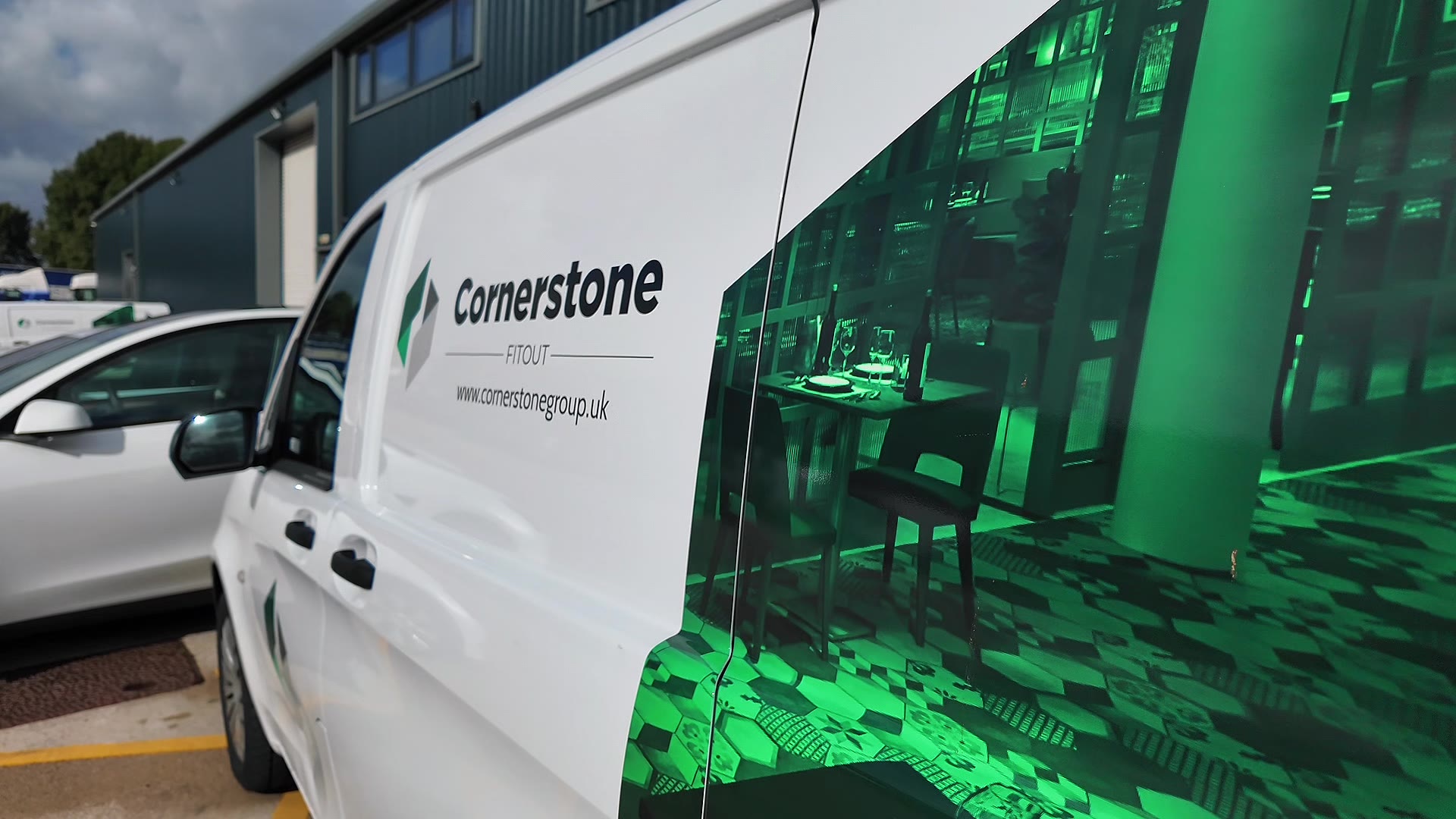 A Cornerstone Group van outside the company's Lancashire workshop, its side panel showing a fit-out interior