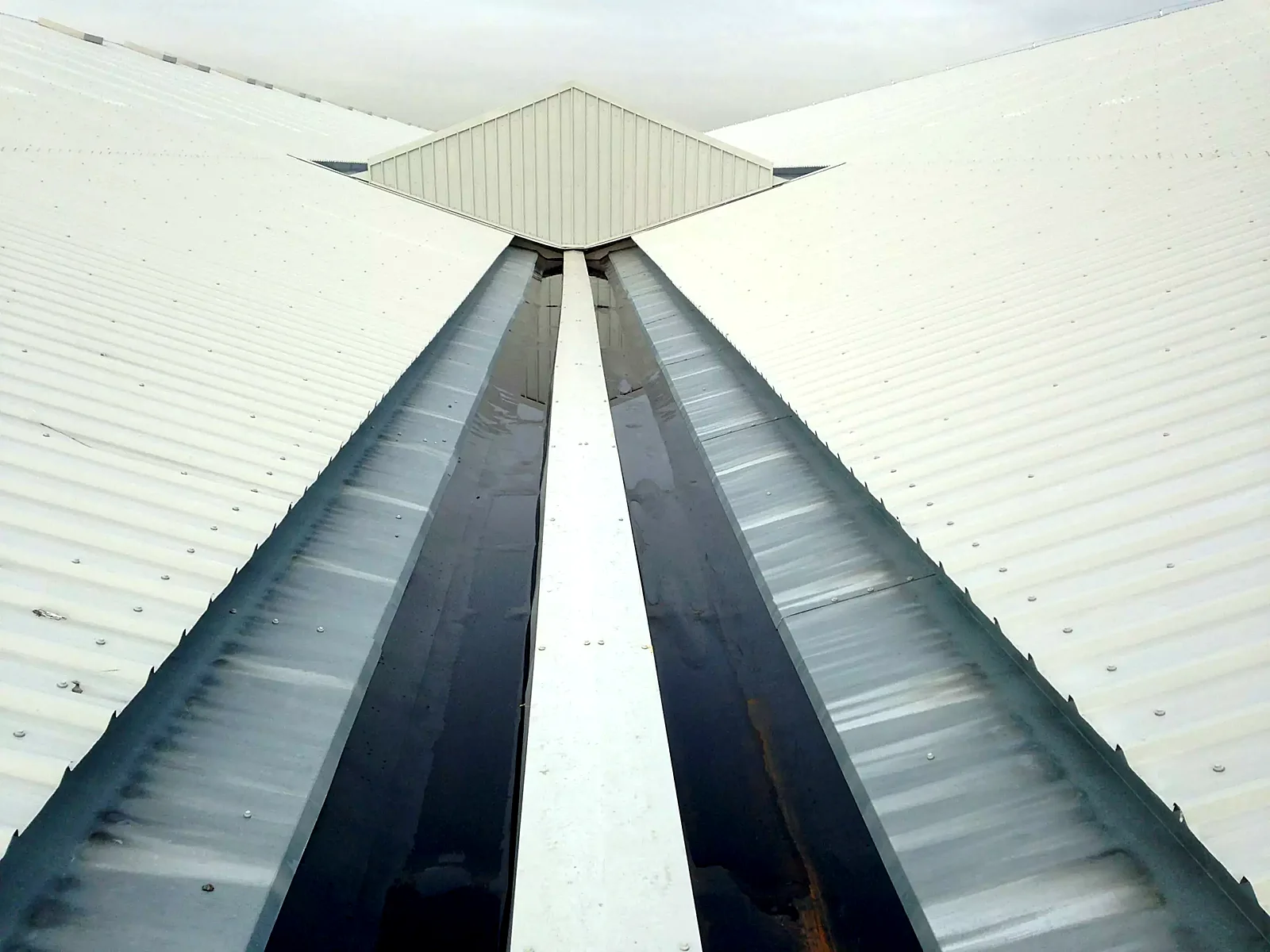 Valley gutter lining running the length of a metal roof
