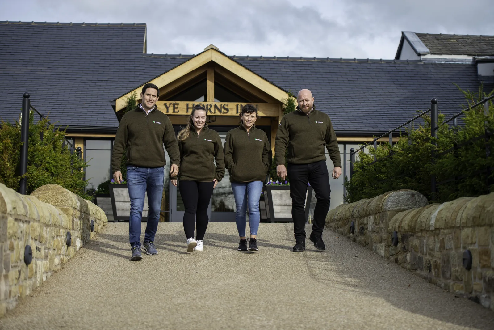 Cornerstone team at the oak-framed entrance of Ye Horns Inn