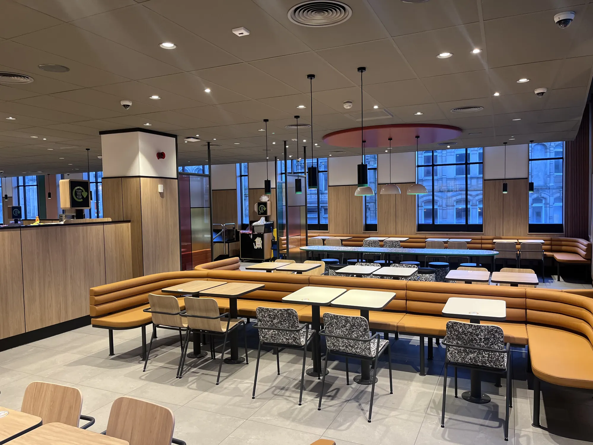 Fast serve restaurant in Halifax, dining area with tan banquette seating, timber panelling and tall windows