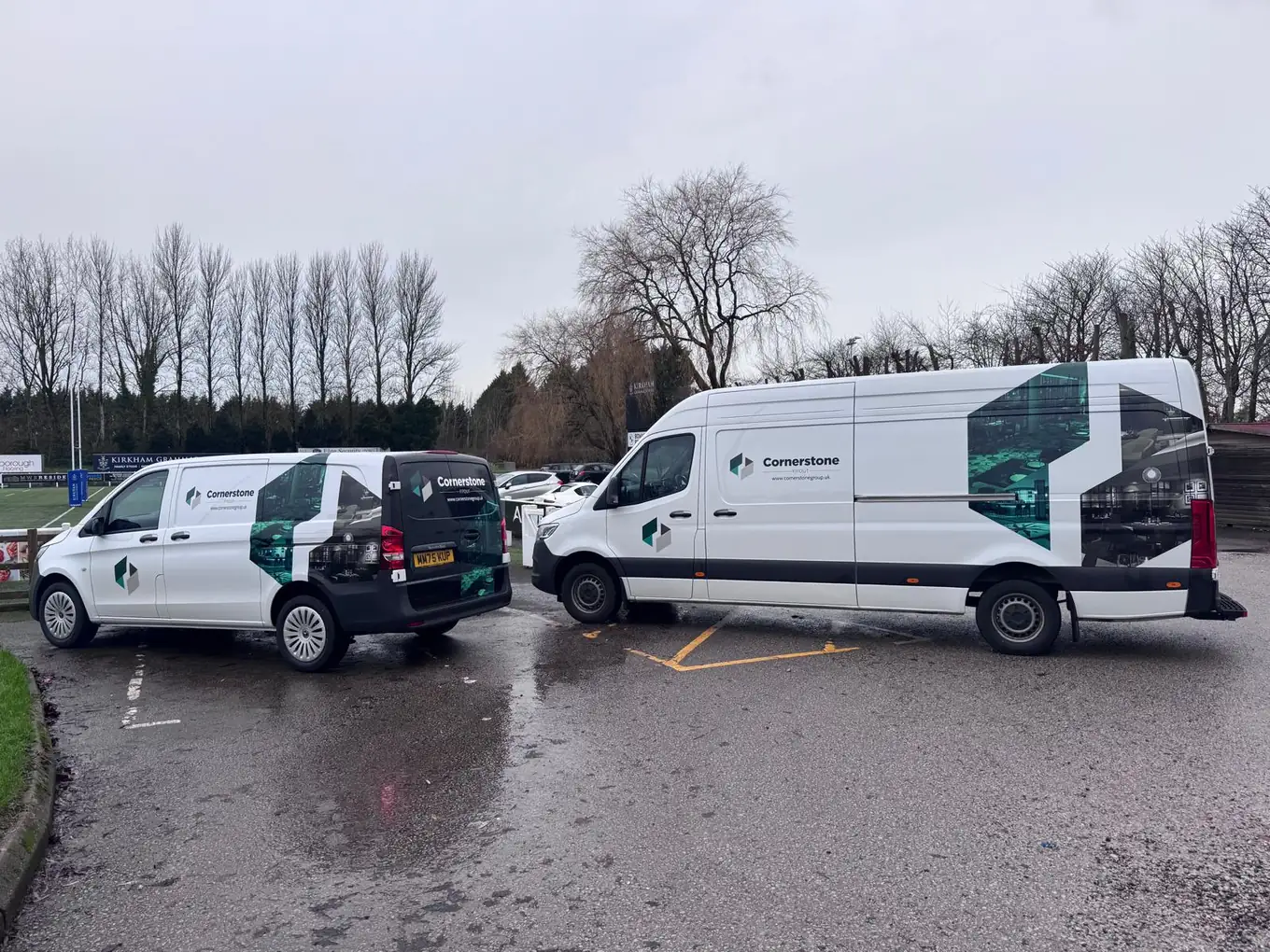 Two Cornerstone liveried vans parked side by side in a car park