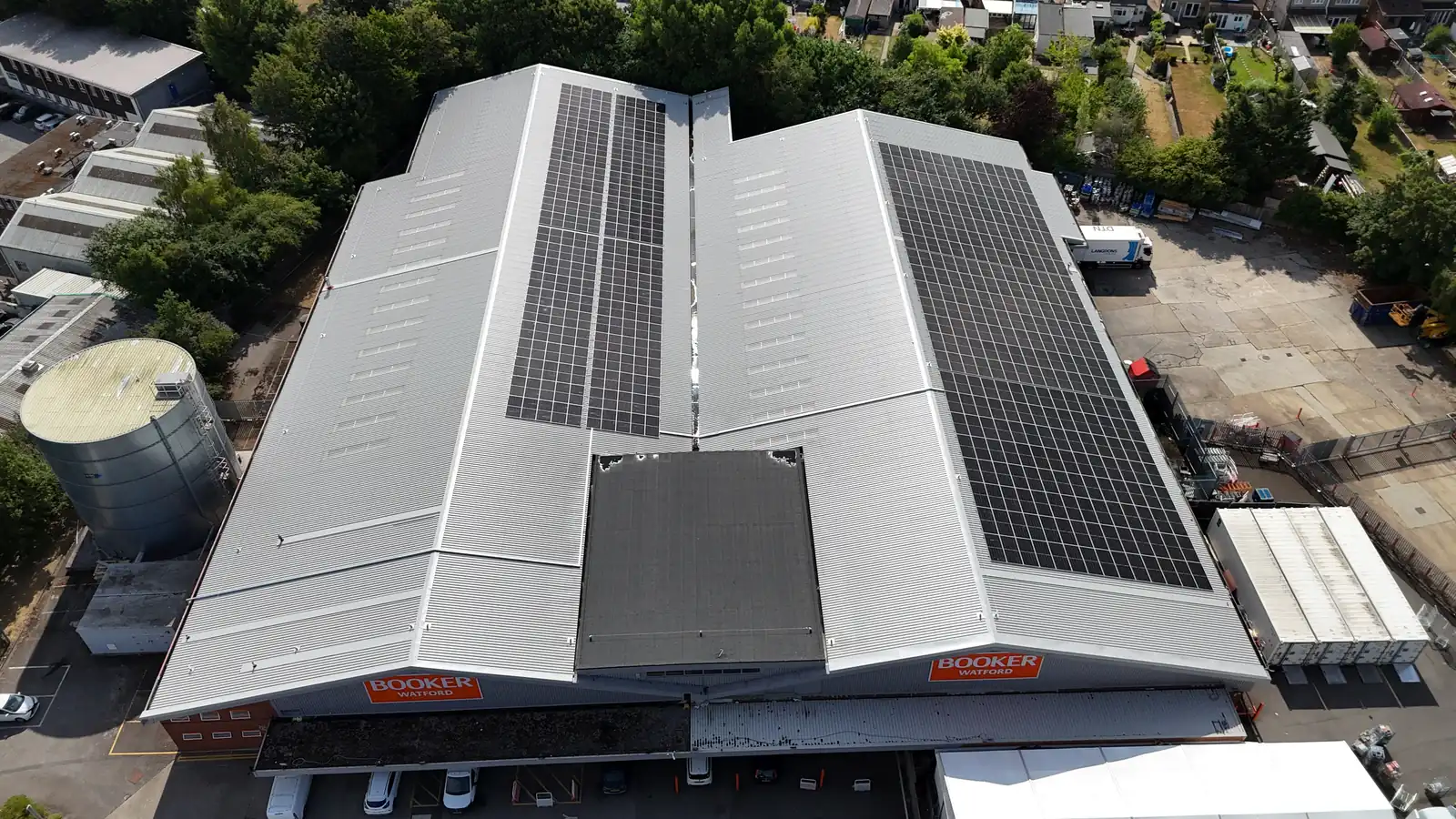 Aerial view of Booker Watford warehouse frontage with solar panels on the roof