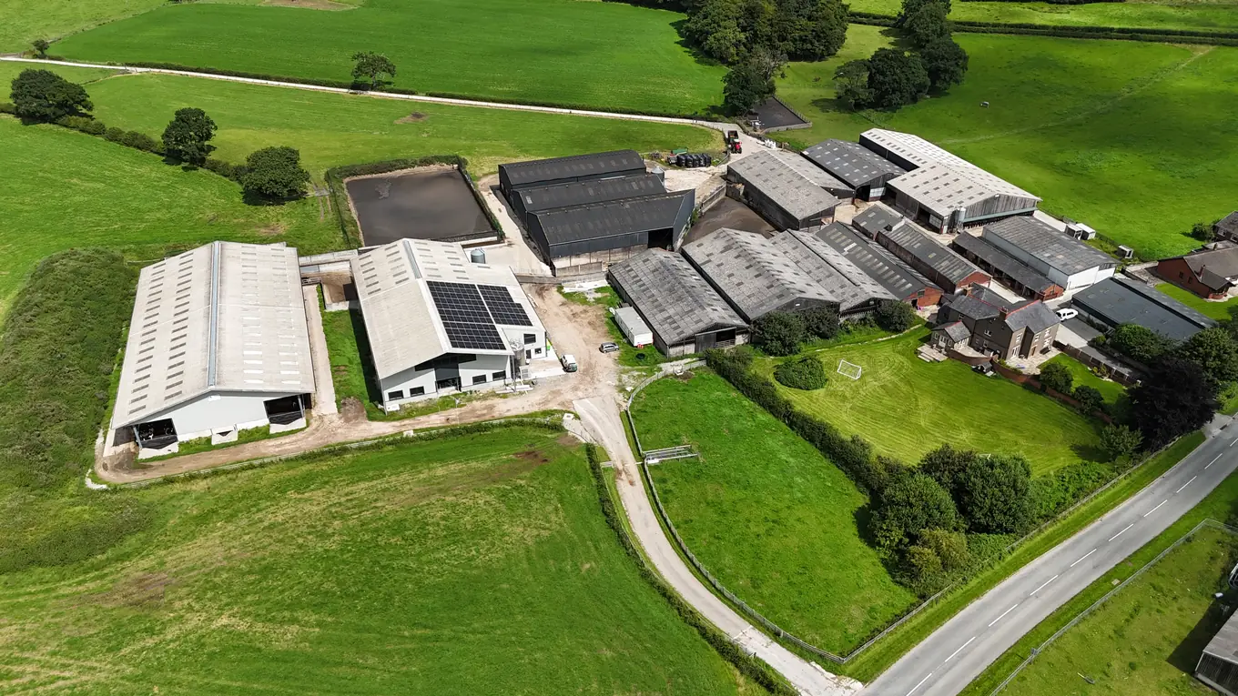 Wide aerial view of Bilsborrow Hall Farm buildings and solar roof set among green Lancashire fields