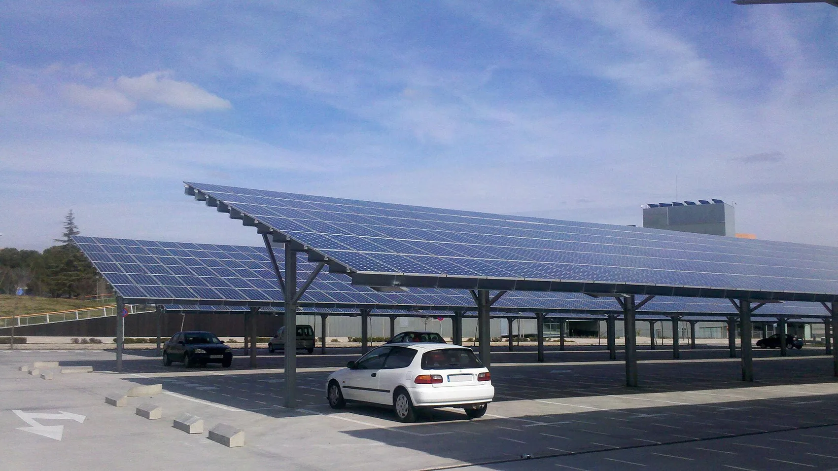 Long rows of solar carport canopies shading parked cars