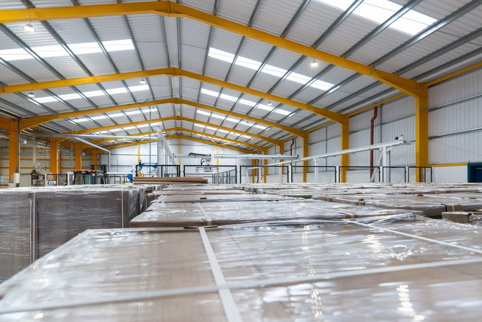 Wrapped panel stock stacked inside the new high bay Watson factory building