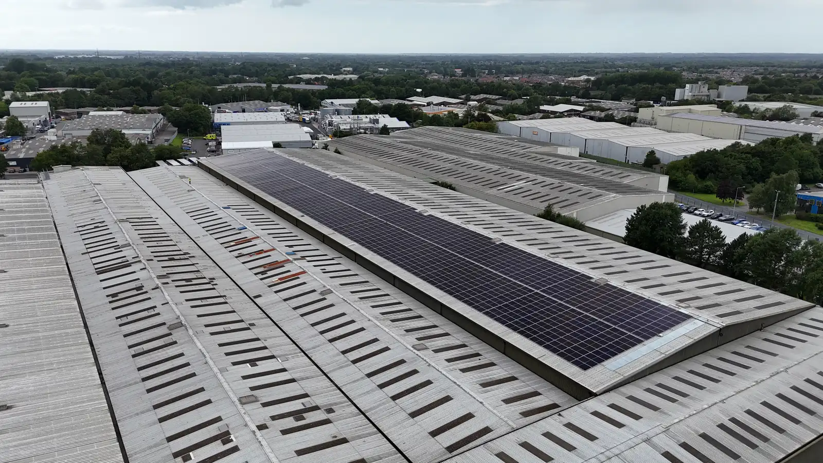 Drone view of solar panels on the FDC warehouse roof with the surrounding industrial estate