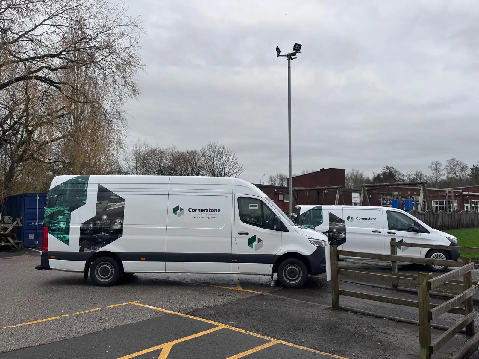 Cornerstone liveried long wheelbase van and second van in a car park