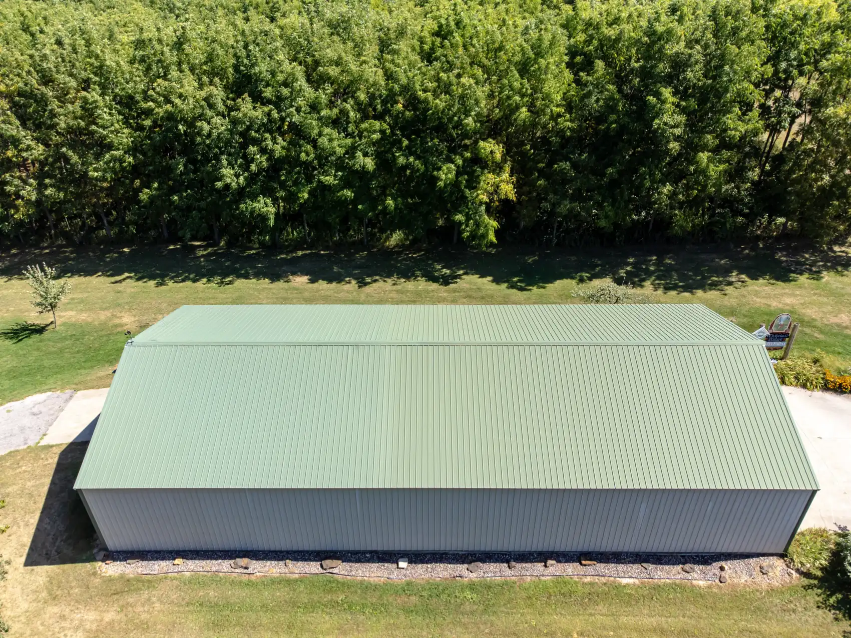 Industrial building with green profiled metal roof and wall cladding