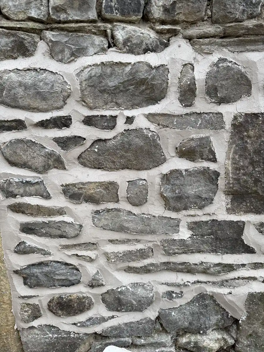 Rubble stonework freshly repointed in lime mortar