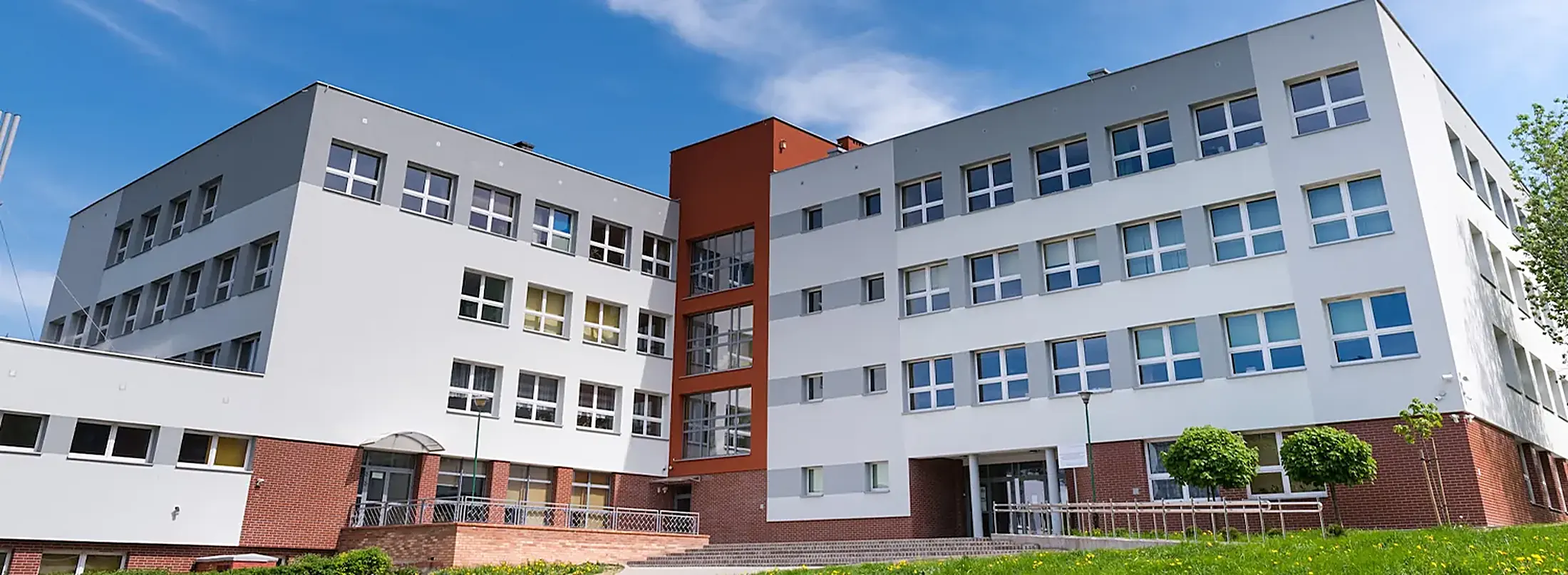 Modern school building with red and white facade